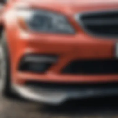 A close-up of a car's front bumper showing damage from an accident.