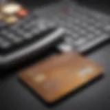 A close-up of a credit card on a desk with a calculator and charts.