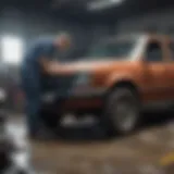 A mechanic assessing a severely damaged car in a workshop