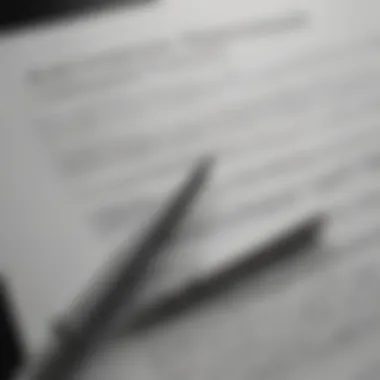 A close-up of an auto insurance policy document with a pen